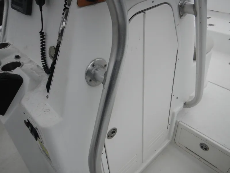 Slide: The Image of 2007 Polar 2100 Center Console boat interior with control panel and storage compartment. - 8