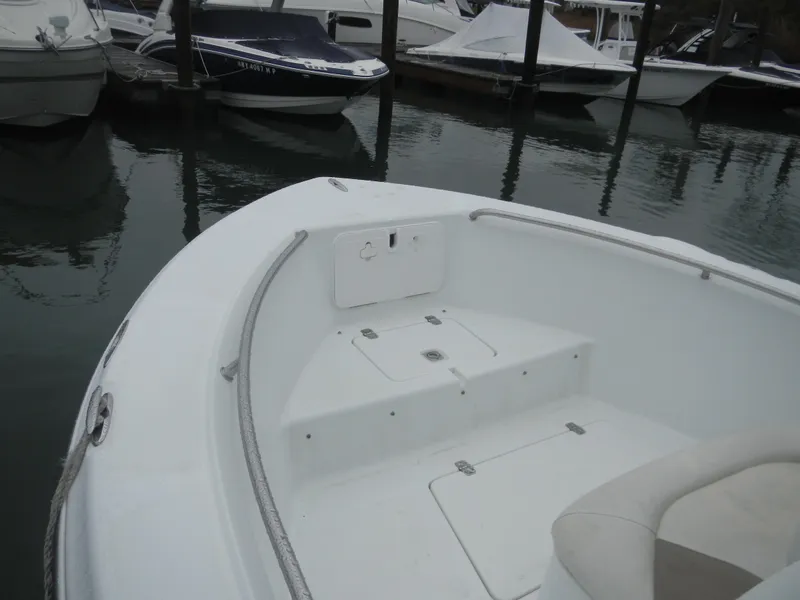Slide: The Image of 2007 Polar 2100 Center Console boat docked, featuring spacious bow seating area. - 9