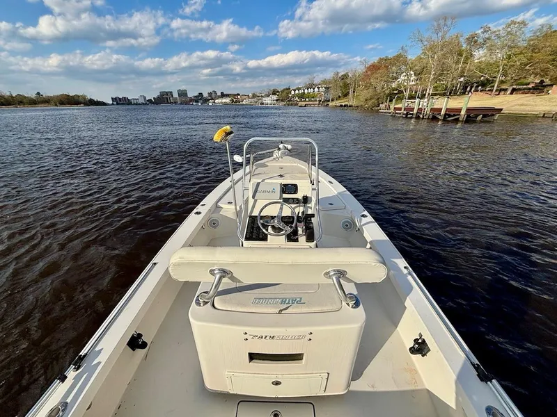 Slide: The Image of 2011 Pathfinder 2300 HPS boat on a scenic river with clear skies. - 11