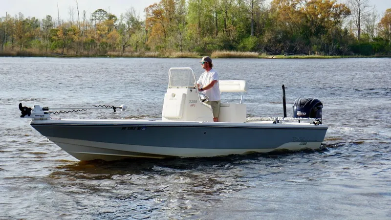 Slide: The Image of Man piloting 2011 Pathfinder 2300 HPS boat on a calm lake. - 3