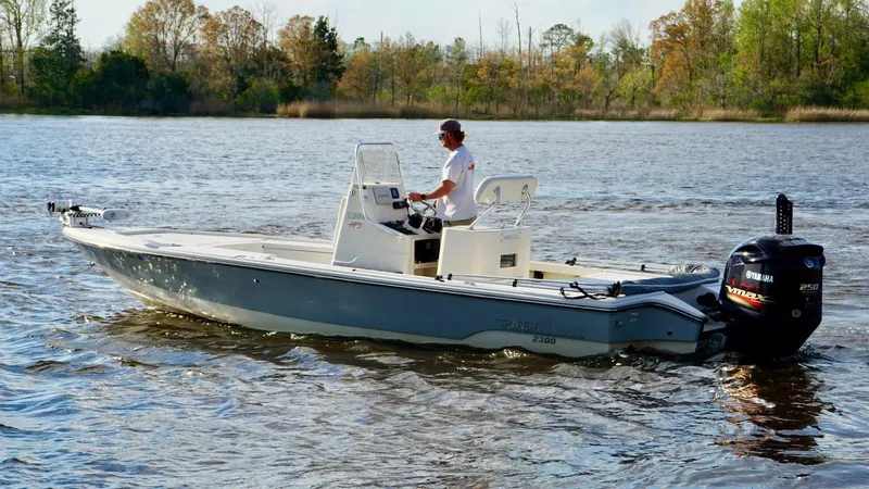 Slide: The Image of 2011 Pathfinder 2300 HPS boat cruising on a calm lake with a person steering. - 4