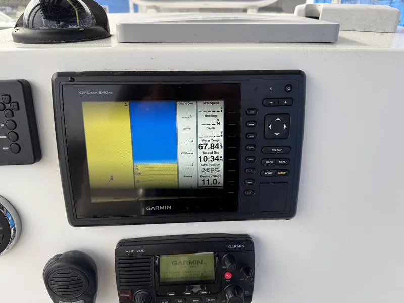 Slide: The Image of Garmin GPS and VHF radio on 2016 Parker 2300 Special Edition boat dashboard. - 13