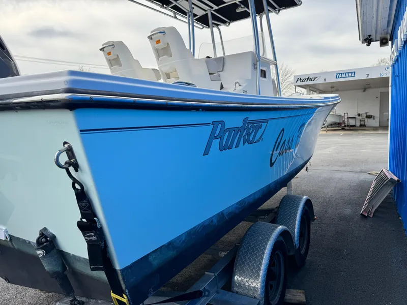 Slide: The Image of 2016 Parker 2300 Special Edition boat on trailer, blue hull, outdoor setting. - 2