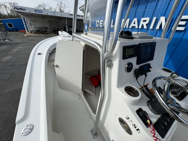 Slide: The Image of 2016 Parker 2300 Special Edition boat at dealership, showcasing console and storage area. - 23