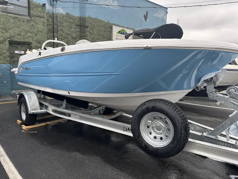 Slide: The Image of 2025 Stingray 172 SC boat on trailer, blue hull, parked outdoors. - 1