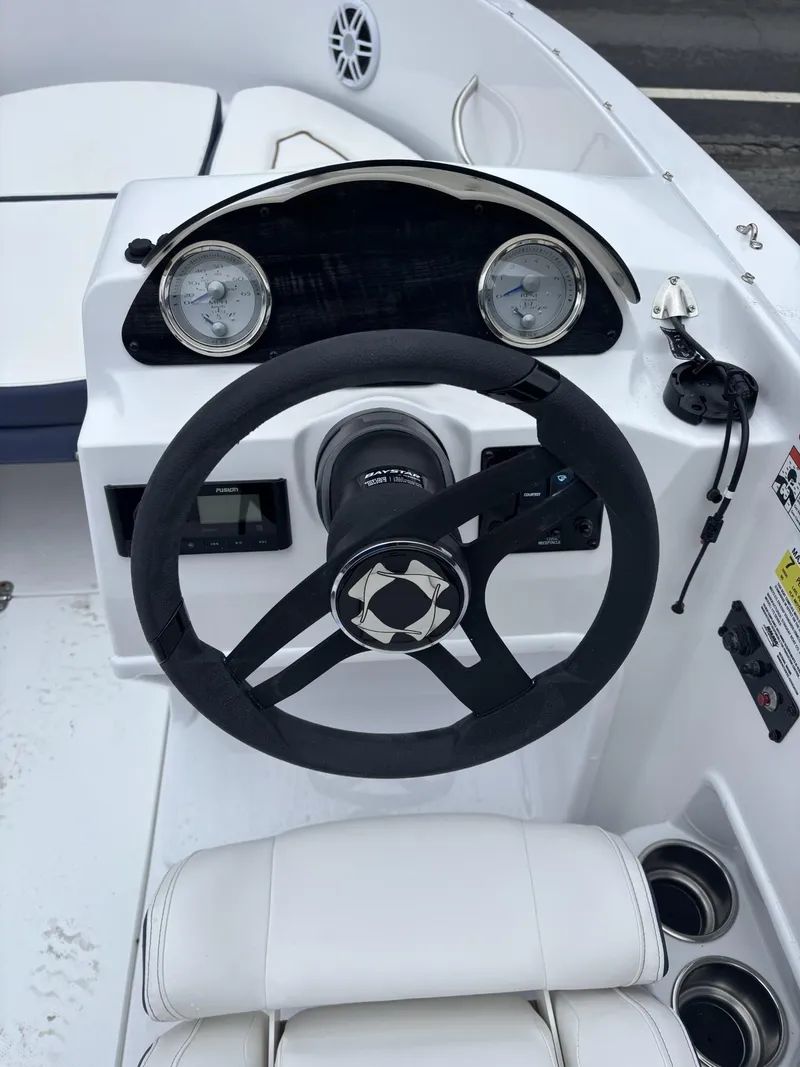 Slide: The Image of Steering console of a 2025 Stingray 172 SC boat with gauges and controls. - 19