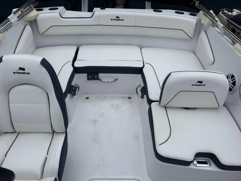 Slide: The Image of 2025 Stingray 172 SC boat interior with white cushioned seating and sleek design. - 21