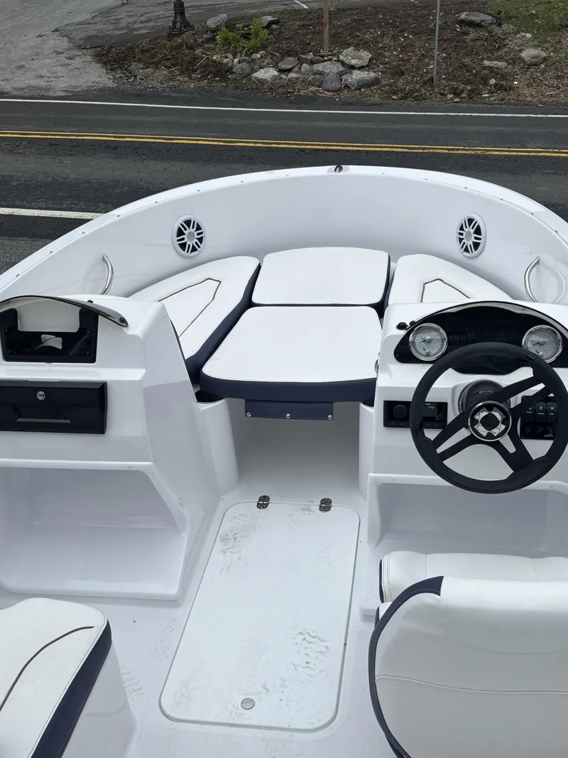 Slide: The Image of 2025 Stingray 172 SC boat interior with white seating and modern dashboard. - 22