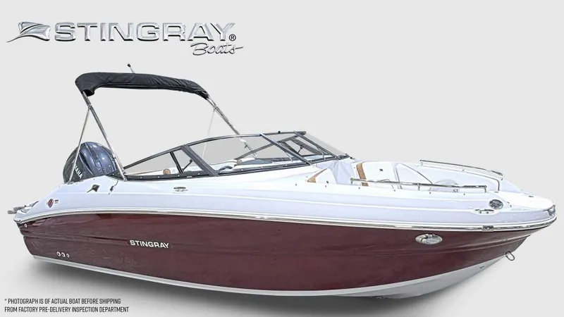 The Image of 2025 Stingray 211 DC boat with maroon hull and black canopy, side view. - 0
