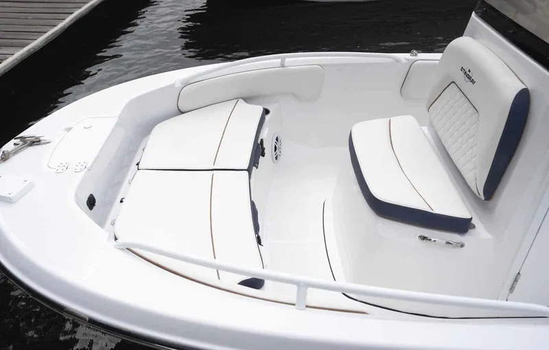 Slide: The Image of 2025 Stingray 173 CC boat interior with white cushioned seating and sleek design. - 11