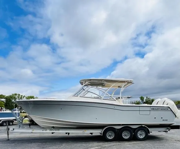 Slide: The Image of 2025 Grady-White Freedom 307 boat on trailer under cloudy sky. - 1