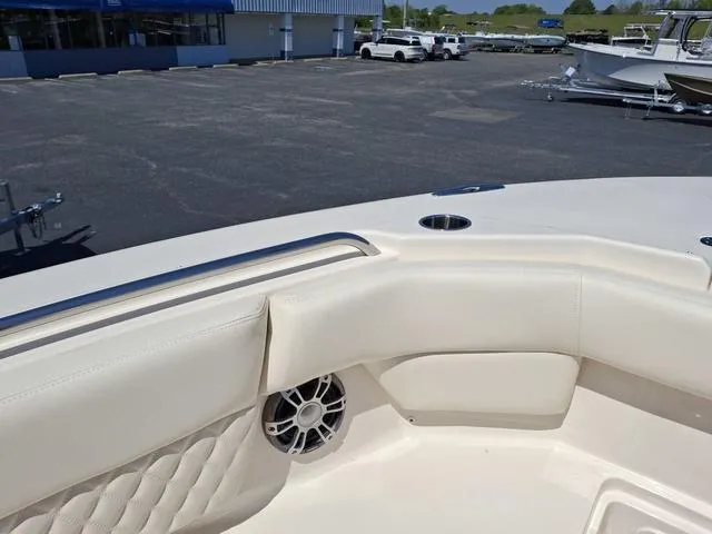 Slide: The Image of 2025 Grady-White Freedom 307 boat interior with cushioned seating and speaker. - 11