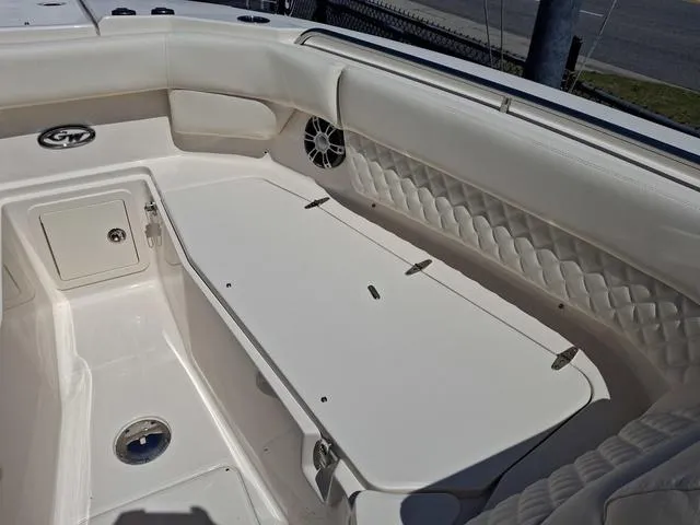 Slide: The Image of 2025 Grady-White Freedom 307 boat interior with white seating and storage compartments. - 13