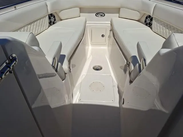 Slide: The Image of 2025 Grady-White Freedom 307 boat interior with white seating and storage compartments. - 19