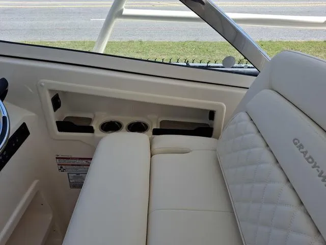 Slide: The Image of 2025 Grady-White Freedom 307 boat interior with beige seating and cup holders. - 21