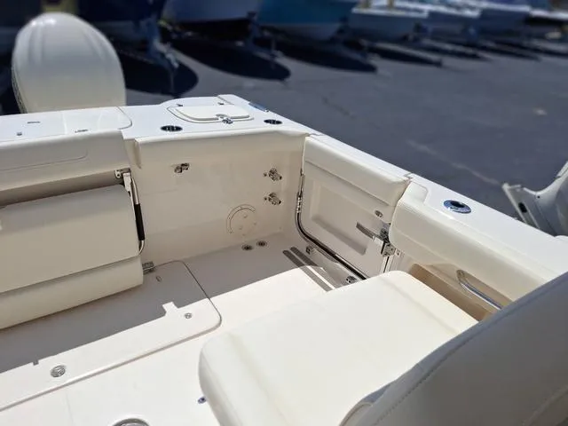 Slide: The Image of 2025 Grady-White Freedom 307 boat interior with beige seating and storage compartments. - 23