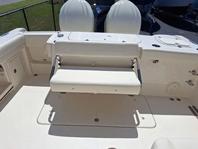 Slide: The Image of 2025 Grady-White Freedom 307 boat interior with foldable seating and dual engines. - 24