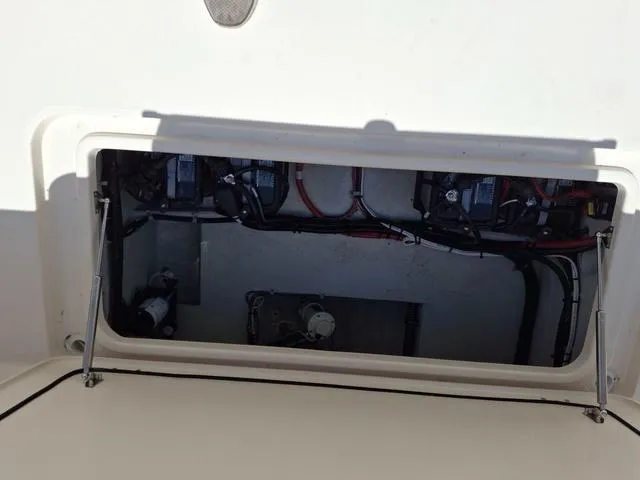 Slide: The Image of 2025 Grady-White Freedom 307 boat compartment with visible wiring and components. - 25