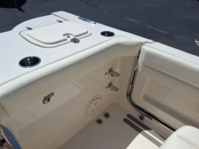 Slide: The Image of 2025 Grady-White Freedom 307 boat interior with cup holders and storage compartments. - 30