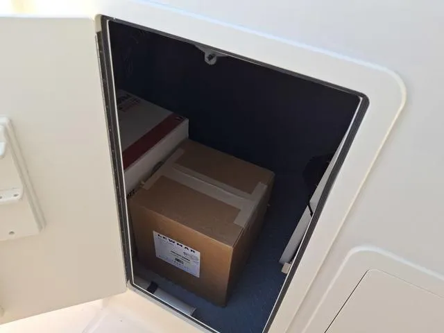 Slide: The Image of Storage compartment on 2025 Grady-White Freedom 307 boat with boxes inside. - 32