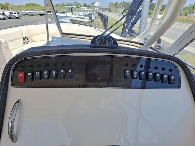 Slide: The Image of 2025 Grady-White Freedom 307 boat dashboard with control panel and navigation instruments. - 34