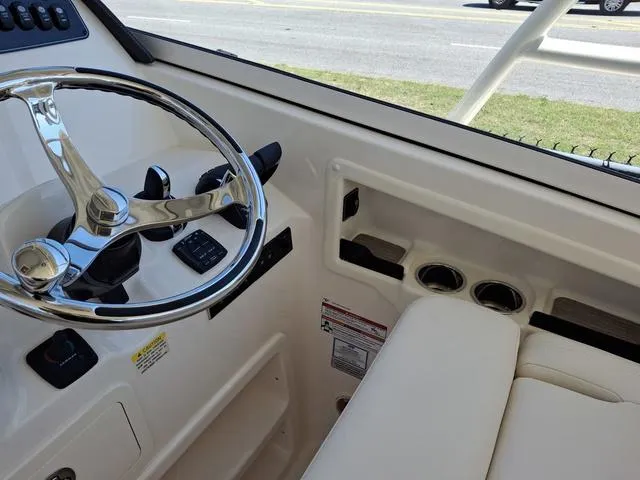 Slide: The Image of 2025 Grady-White Freedom 307 boat interior with steering wheel and seating area. - 36