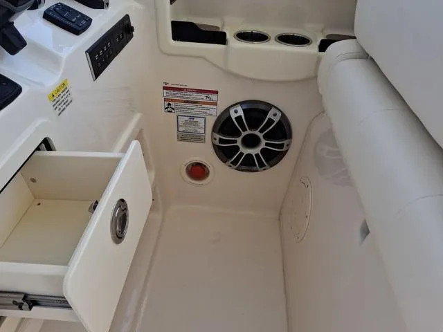 Slide: The Image of Interior of 2025 Grady-White Freedom 307 boat with open storage drawer and speaker. - 38