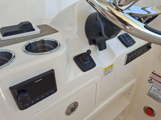 Slide: The Image of Control panel of 2025 Grady-White Freedom 307 boat with steering wheel and electronics. - 40