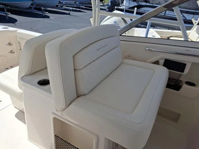 Slide: The Image of 2025 Grady-White Freedom 307 boat interior with cushioned seating and cup holder. - 41