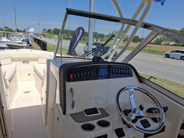 Slide: The Image of 2025 Grady-White Freedom 307 boat interior with steering wheel and control panel. - 44