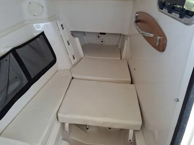 Slide: The Image of 2025 Grady-White Freedom 307 cabin interior with cushioned seating and storage. - 45