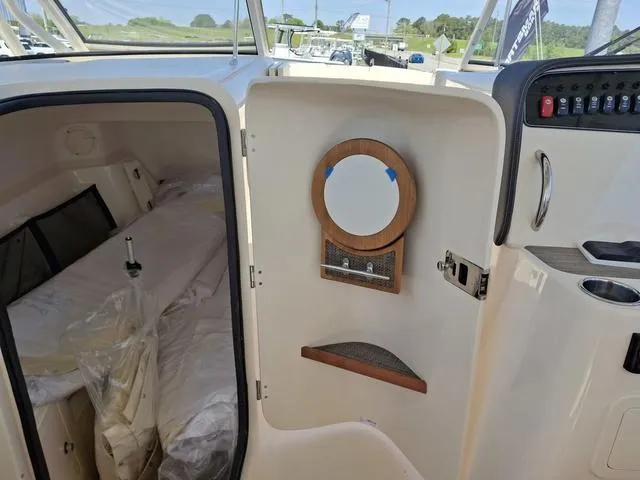 Slide: The Image of 2025 Grady-White Freedom 307 cabin interior with mirror and control panel. - 49