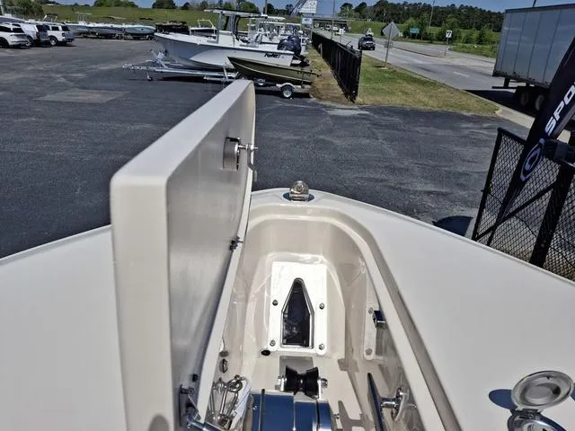 Slide: The Image of 2025 Grady-White Freedom 307 boat anchor compartment, open lid, outdoor display. - 9