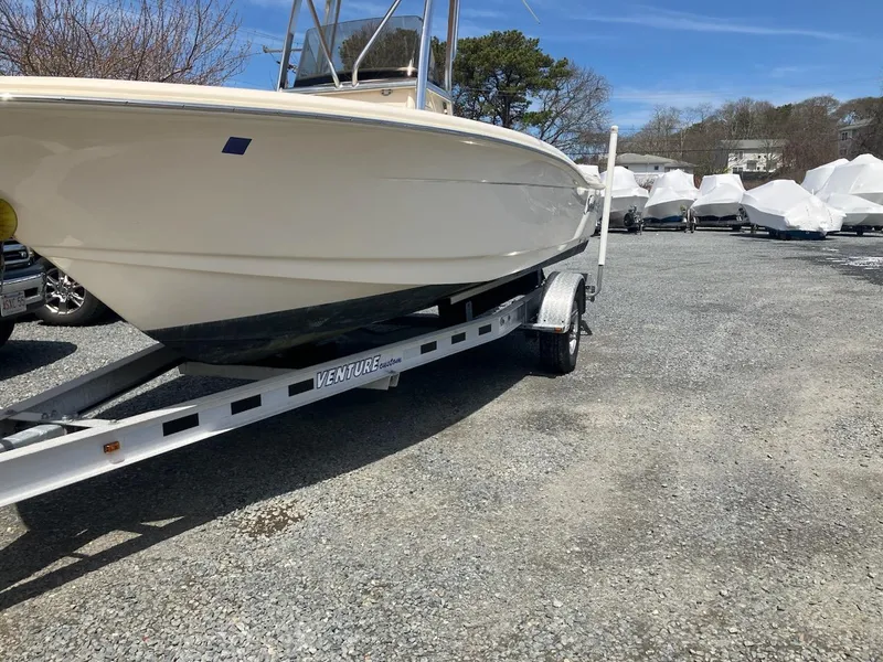 Slide: The Image of 2021 Scout 195 Sportfish boat on trailer in outdoor storage area. - 10