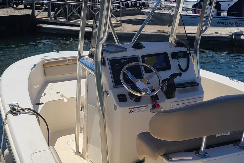 Slide: The Image of 2021 Scout 195 Sportfish boat interior with steering console at marina. - 3