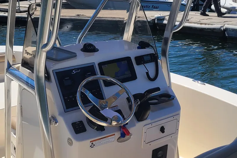 Slide: The Image of 2021 Scout 195 Sportfish boat console with steering wheel and navigation equipment. - 4