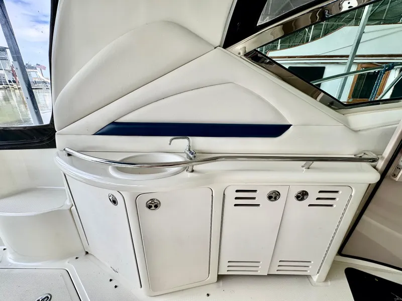 Slide: The Image of 2004 Sea Ray 420 Sundancer yacht interior with sink and storage cabinets. - 11
