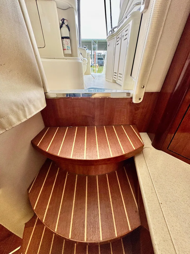 Slide: The Image of Wooden steps inside a 2004 Sea Ray 420 Sundancer yacht, featuring elegant design and craftsmanship. - 14