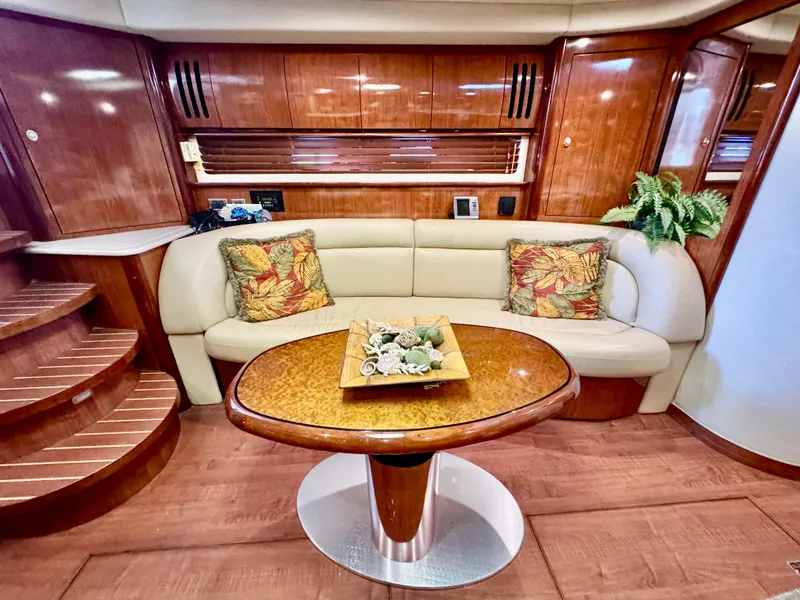 Slide: The Image of Luxurious 2004 Sea Ray 420 Sundancer interior with elegant wood finish and cozy seating area. - 16