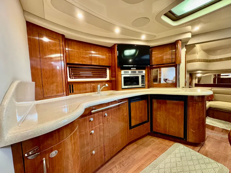 Slide: The Image of Luxurious 2004 Sea Ray 420 Sundancer yacht interior with elegant wood cabinetry and modern amenities. - 17