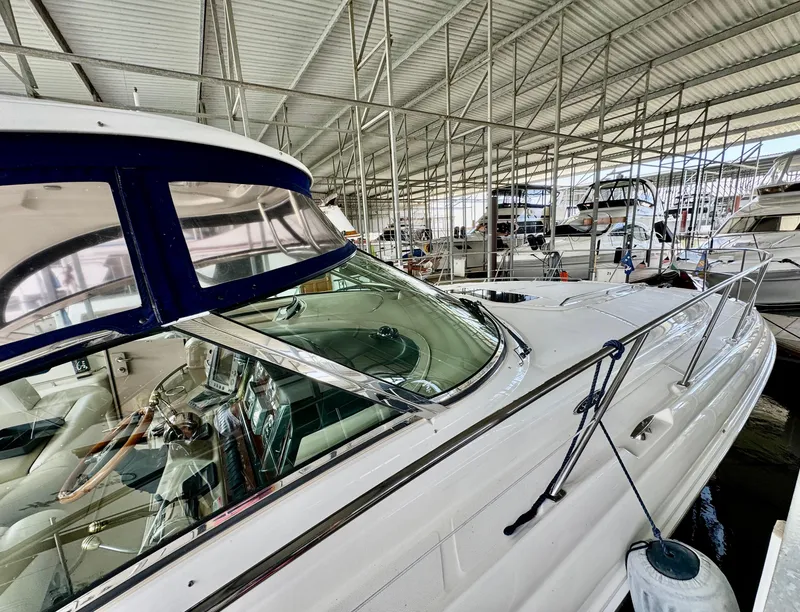 Slide: The Image of 2004 Sea Ray 420 Sundancer yacht docked in a covered marina. - 2