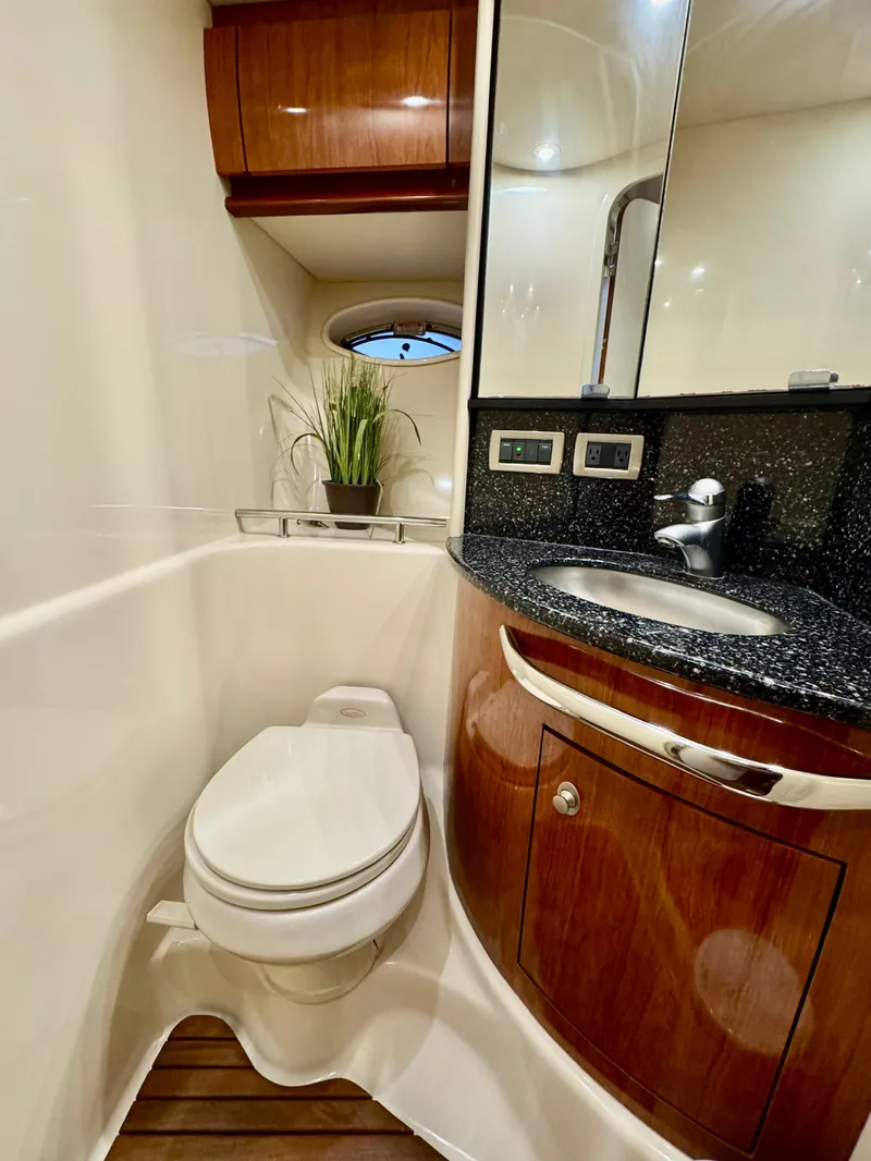 Slide: The Image of Luxurious bathroom in 2004 Sea Ray 420 Sundancer yacht with modern fixtures and wood accents. - 21