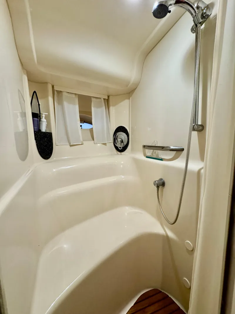 Slide: The Image of 2004 Sea Ray 420 Sundancer shower with white interior and handheld showerhead. - 22