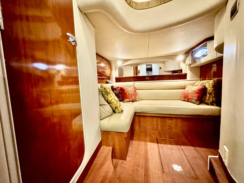 Slide: The Image of Luxurious interior of 2004 Sea Ray 420 Sundancer yacht with plush seating and wood finishes. - 24
