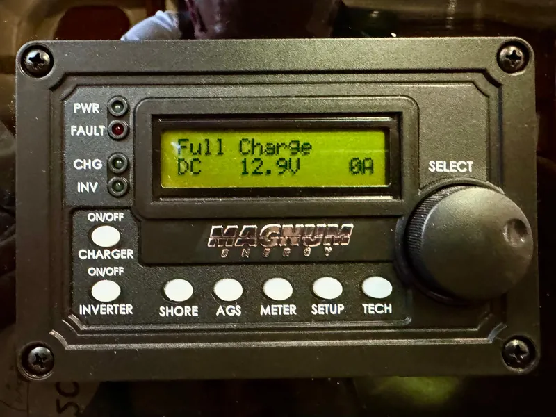 Slide: The Image of Magnum Energy control panel displaying full charge at 12.9V, Sea Ray 420 Sundancer 2004. - 27