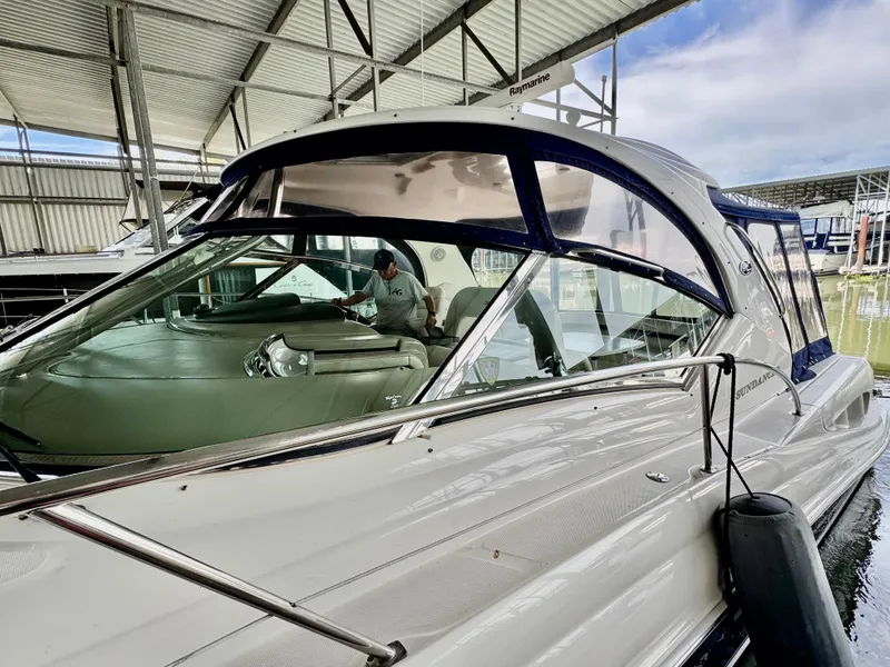Slide: The Image of 2004 Sea Ray 420 Sundancer yacht docked in a marina under a metal roof. - 3