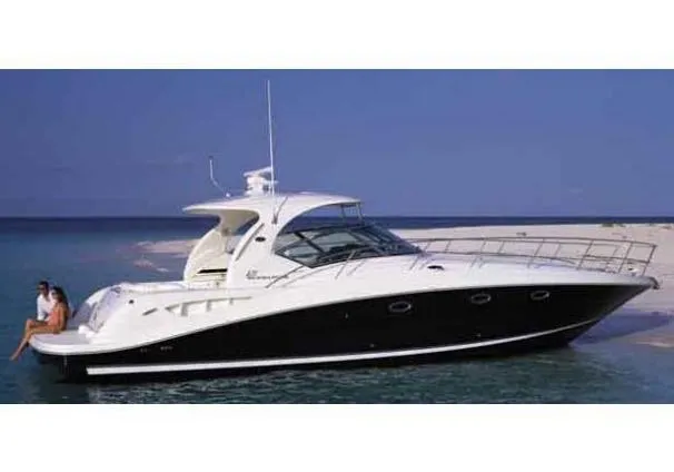 Slide: The Image of 2004 Sea Ray 420 Sundancer yacht anchored near a sandy beach. - 31