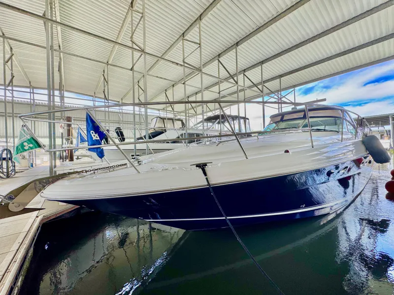 Slide: The Image of 2004 Sea Ray 420 Sundancer yacht docked in a covered marina. - 4