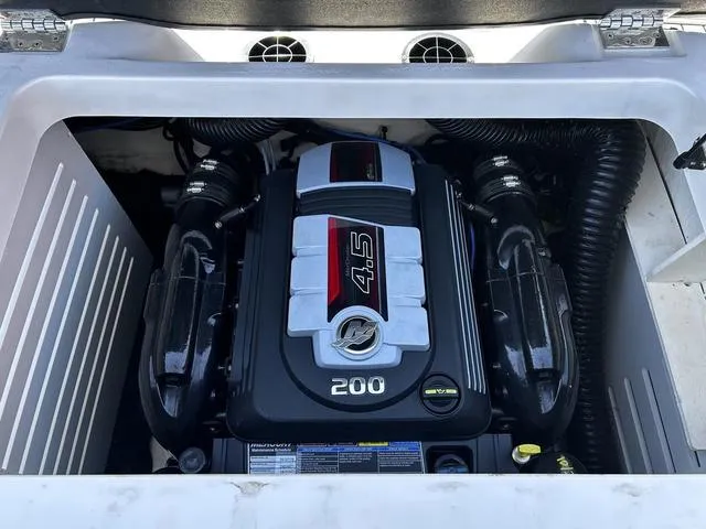 Slide: The Image of Engine compartment of 2023 Sea Ray SPX 210 boat, featuring a 4.5L 200 horsepower engine. - 13