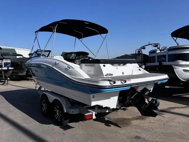 Slide: The Image of 2023 Sea Ray SPX 210 boat on trailer, featuring sleek design and bimini top. - 3